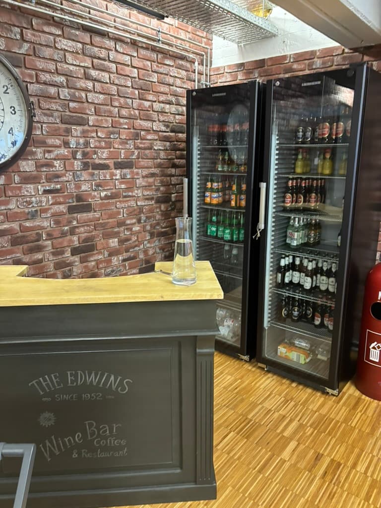 The Edwins — Nandu's office bar with brick wall and stocked fridges